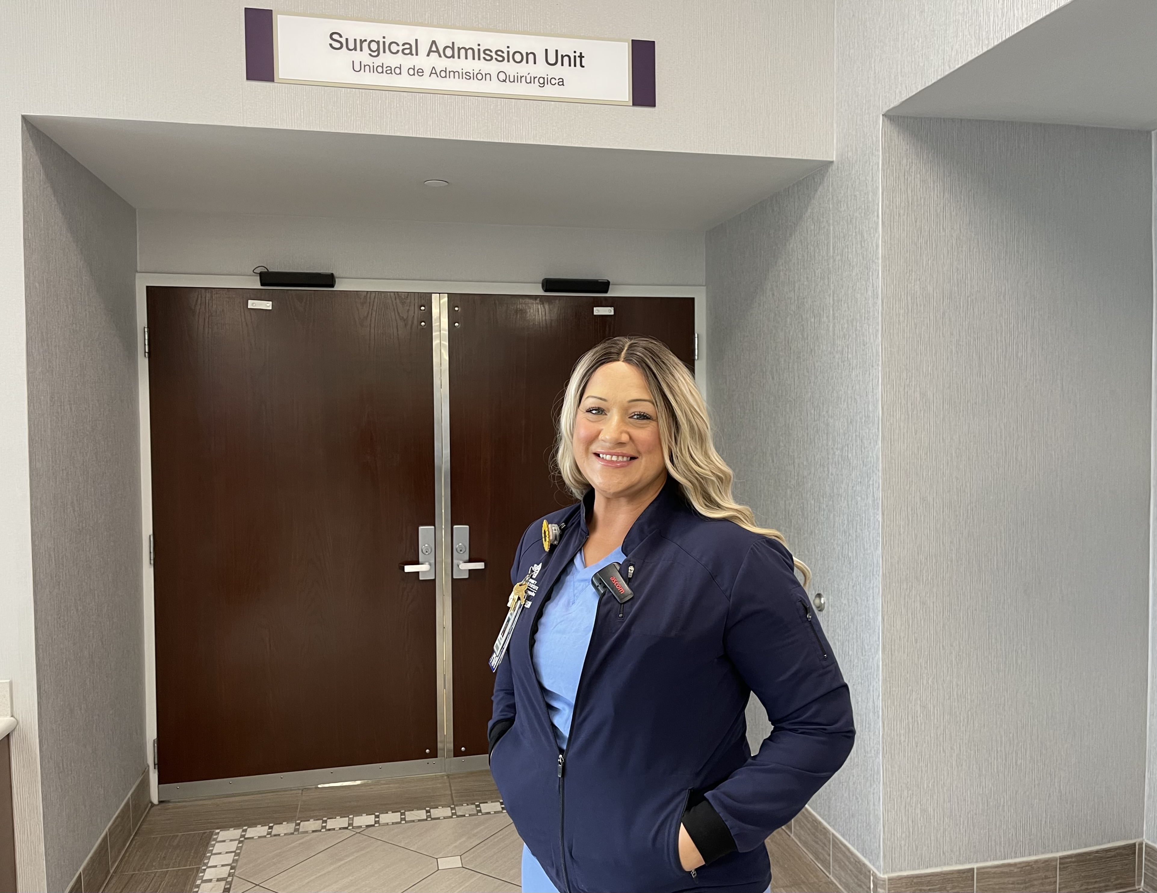 Lauren Allard standing in a hallway outside the Surgical Admission Unit